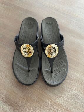 CROCS Black Thong Sandals with Gold Accent Medallions